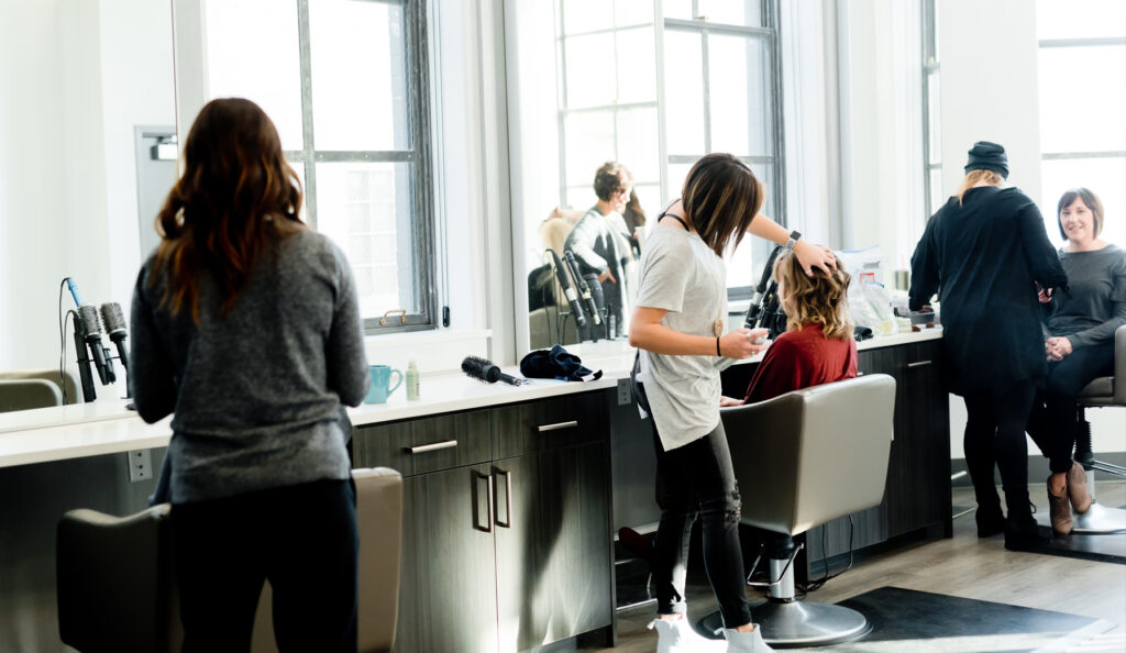 students-in-salon Students cutting hair in salon